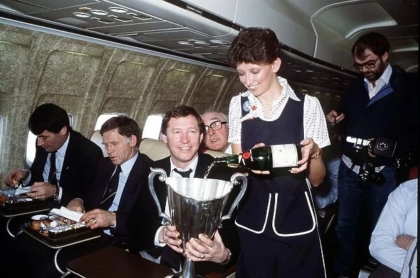 Aberdeen manager Alex Ferguson receives champagne for an air hostess inthe European Cup