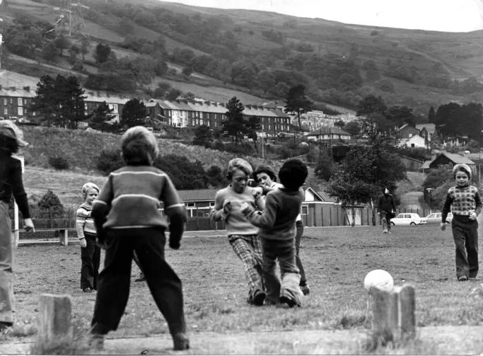 Framed Print : Aberfan - Schoolchildren play football on the playing field