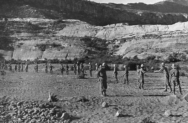 Abyssinian War October 1935 Italian troops passing stones down a human chain for