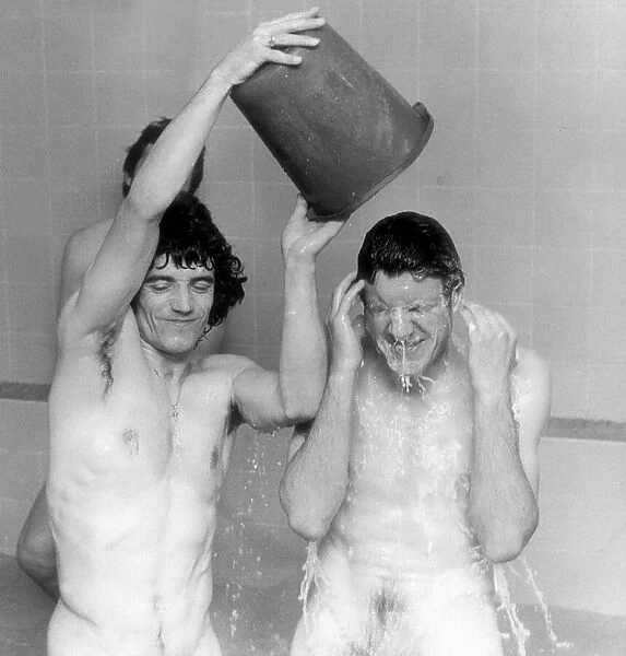 ace Kevin Keegan pours a bucket of water May 1977 over team mate Emlyn Hughes