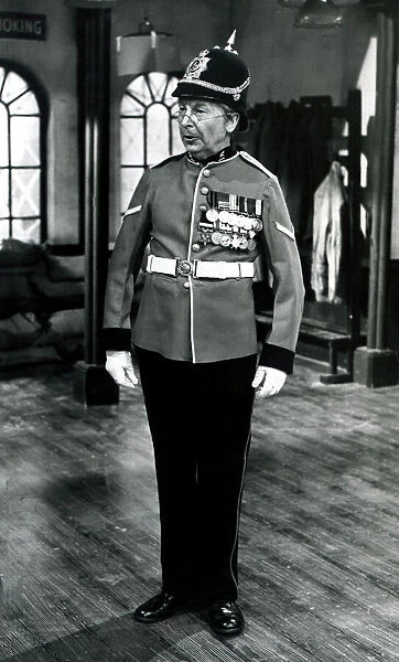 Acotrs Dads Army - Clive Dunn wearing a soldiers uniform with medals and a hat