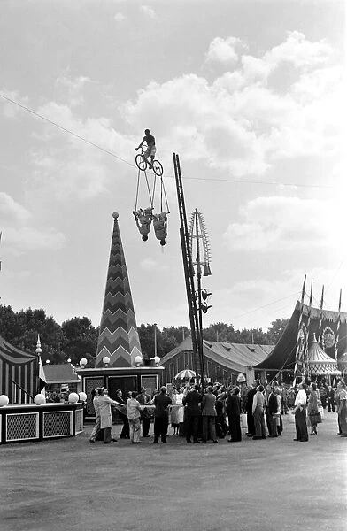 Acrobats and man riding a highrope on a bicycle at Battesea Pleasure Gardens