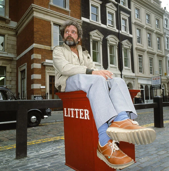 Actor David Jason pictured in Covent Garden, London, sitting on a litter bin. July 1985