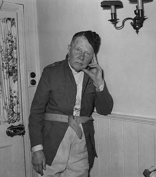Actor A E Matthews wearing army uniform leans his head onto his fingers
