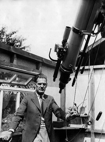 Actor Will Hay seen here with his 12 and a half foot telescope in his back garden