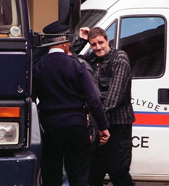 Actor Iain McColl is led away from court into a police van after he was remanded in