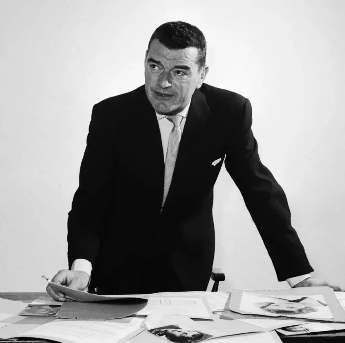 Framed Print : Actor Jack Hawkins looking at photographs on his desk April 1958