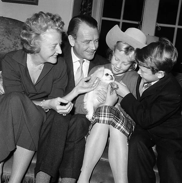 Actor John Mills at home with his wife Mary Hayley Bell and two of their children
