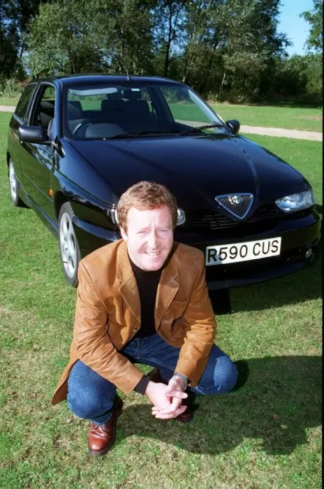 Framed Print : Actor Jonathan Watson September 1997 after testing ALFA ROMEO 145 kneeling in front of Framed Print : Actor Jonathan Watson September 1997 after testing ALFA ROMEO 145 kneeling in front of