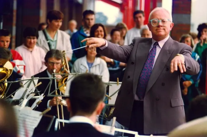 Framed Print : Actor Ken Morley hamming it up with the Eveready Brass Band when he opened by new MFI