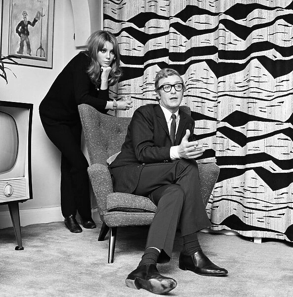 Actor Michael Caine pictured with French actress Miss Elizabeth Ercy in the flat of