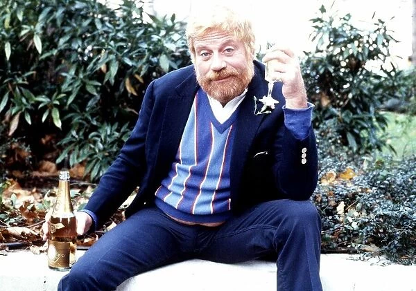 Actor Oliver Reed with a drink in November 1986