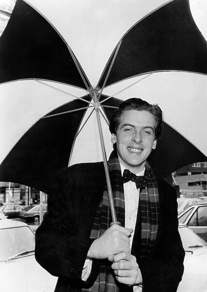 Actor Peter Capaldi holding an umbrella. March 1983