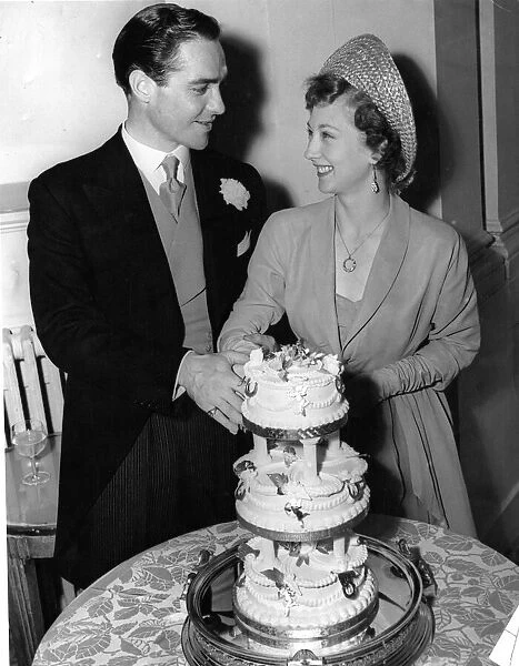 Actor Richard Todd with his bride Catherine Bogle cutting the cake on their wedding day