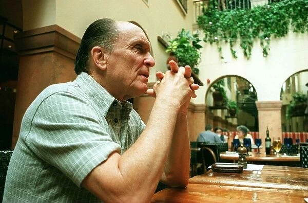Actor Robert Duvall in Glasgow May 1998 elbows on table hands clasped