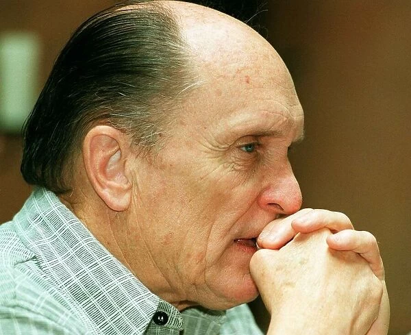 Actor Robert Duvall in Glasgow May 1998 hands clasped at face biting nail