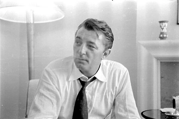 Actor Robert Mitchum during a press interview in London. July 1955