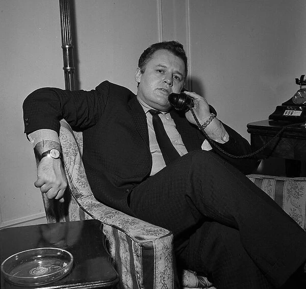 Actor Rod Steiger in London talking on the phone in his hotel room December