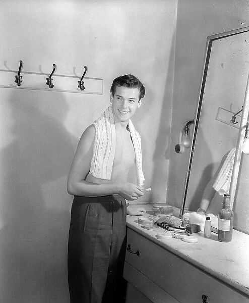 Actor Roger Moore getting ready in his dressing room March 1952