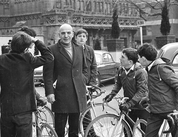 Actor Savalas Telly, surronded by young fans with bikes
