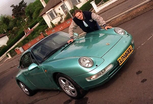 Actor Simon Weir leaning on the bonnet of the Porsche 911 Targa May 1997
