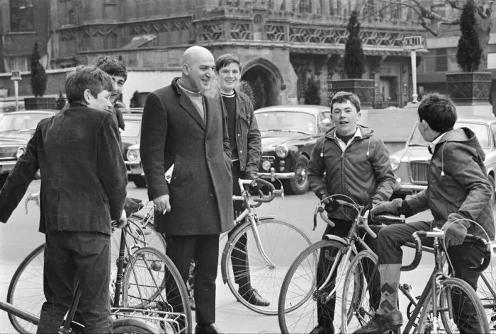 Framed Print : Actor Telly Savalas, surrounded by young fans with bikes