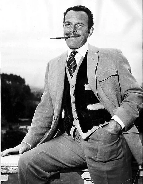 Actor Terry Thomas smoking a cigarette May 1959