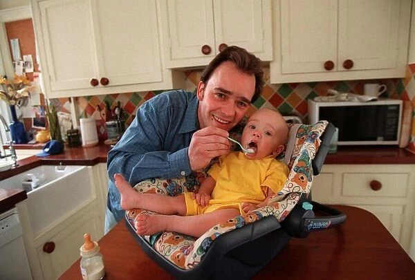 Actor Todd Carty at home with baby son James, June 1997