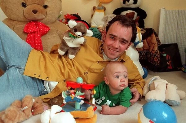 Actor Todd carty at home with baby son James, June 1997