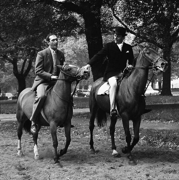 Actors Bernard Bresslaw and Terry Thomas horse riding 1958