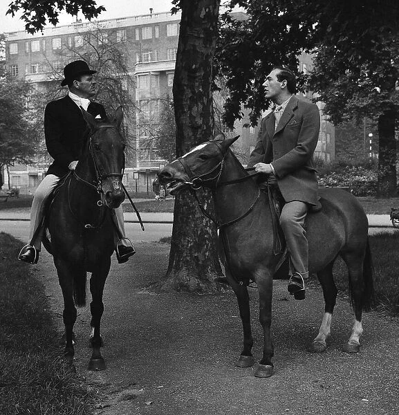 Actors Bernard Bresslaw and Terry Thomas horse riding 1958