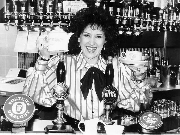 Actress Anita Dobson from Eastenders TV programme on set having cup of tea behind bar of