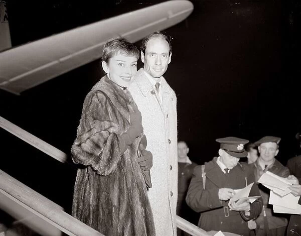 Actress Audrey Hepburn arrives in London Airport with husband December 1954