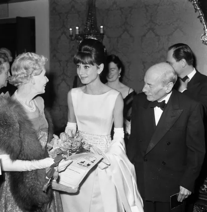 Framed Print : Actress Audrey Hepburn pictured with Earl and Countess Attlee at the London premiere of
