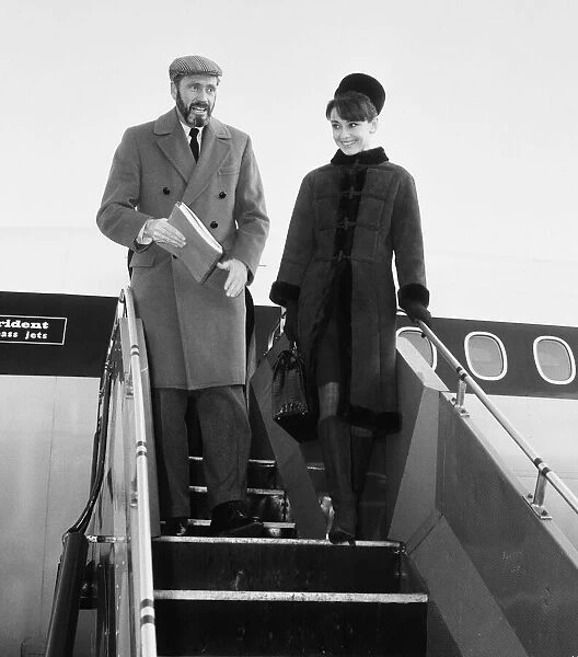 Actress Audrey Hepburn pictured with her husband Mel ferrer arriving in London