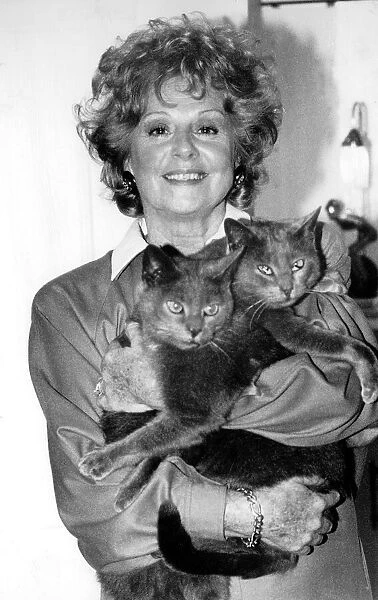 Actress Barbara Knox October 1988 holding two cats