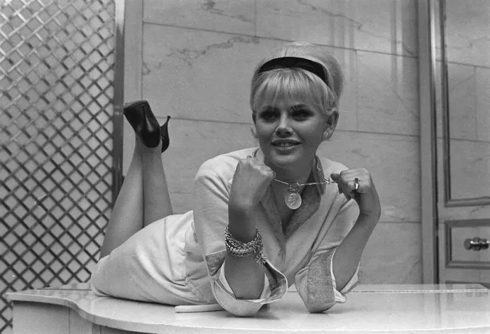 Framed Print : Actress Britt Ekland, holding a pendant from around her neck circa 1960s Framed Print : Actress Britt Ekland, holding a pendant from around her neck circa 1960s