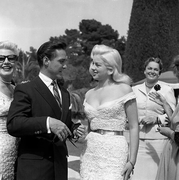 Actress Diana Dors chatting with Richard Todd at the Cannes film Festival