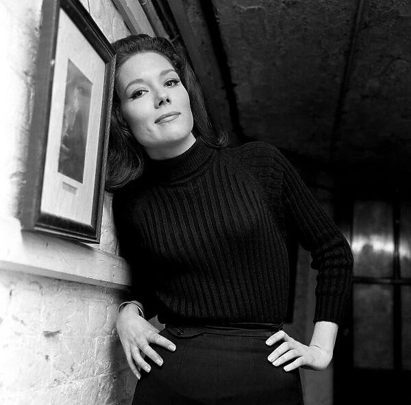 Actress Diana Rigg, star of The New Avengers, leaning against a wall with her hands