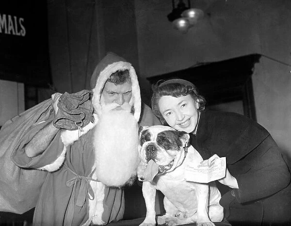 Actress Dulcie Gray recieves a cheque from a bulldog watched by Major F N L Chapman