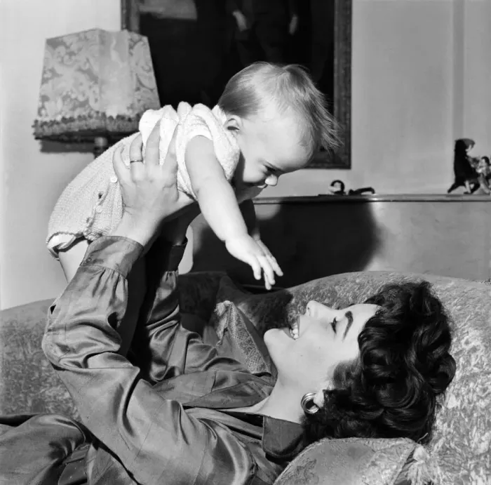 Framed Print : Actress Elizabeth Taylor at home with her baby son Michael. September 1953 D5729-003