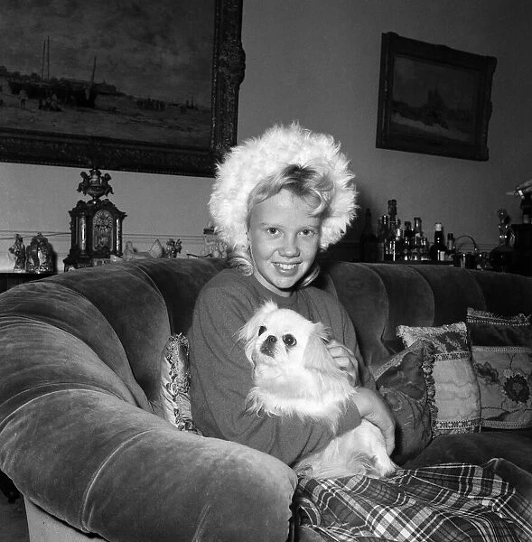Actress Hayely Mills at home with her pet dog. 31st December 1959