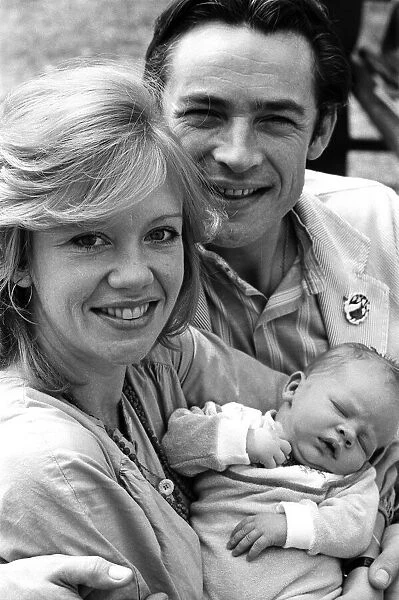Actress Hayley Mills and actor Leigh Lawson proudly show off their love child for