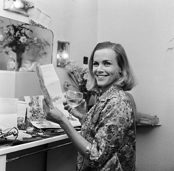 Actress Honor Blackman reads telegrams of congratulations in her dressing room at