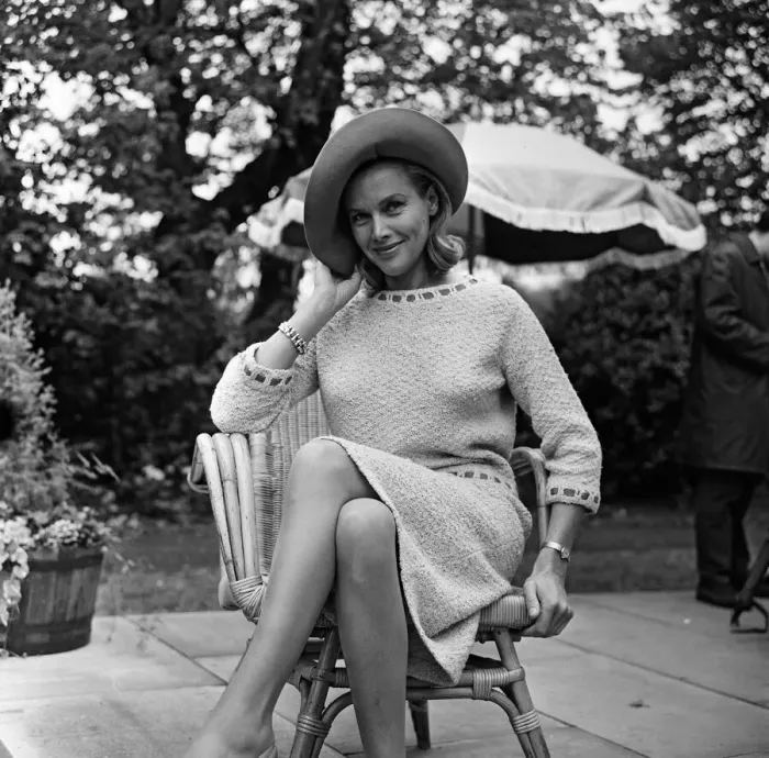 Framed Print : Actress Honor Blackman relaxes in her garden party outfit during the filming of Framed Print : Actress Honor Blackman relaxes in her garden party outfit during the filming of