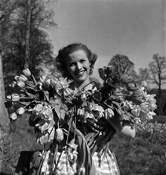 Actress Honor Blackman seen here with flowers in the gardens of Pinewood studio