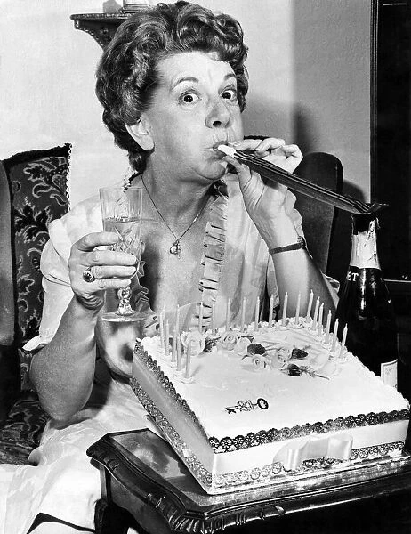 Actress Jean Alexander gets the party spirit-with champagne, cake and key of the door
