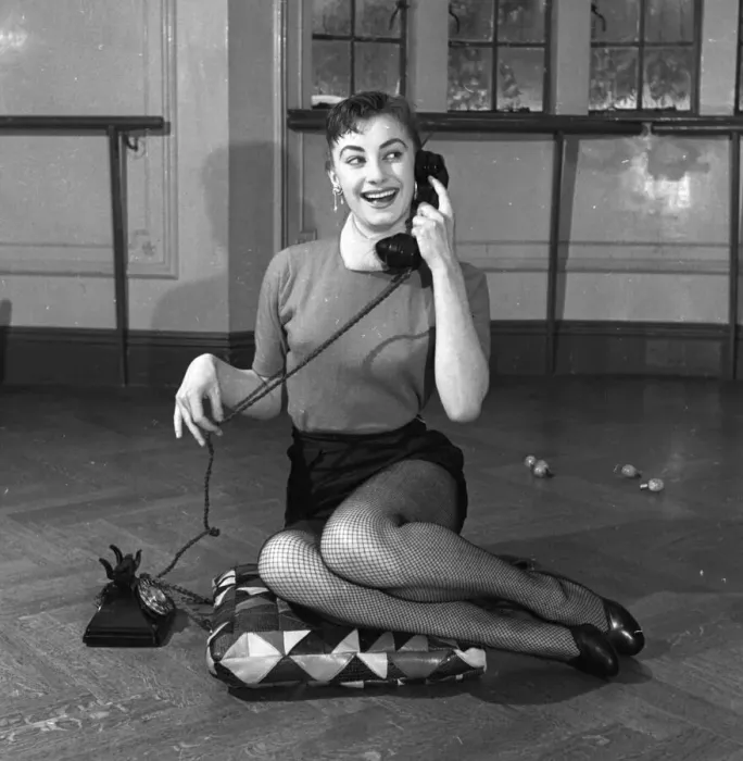 Framed Print : Actress Jean Marsh aged 17 posing sitting ona cushion and holding a phone