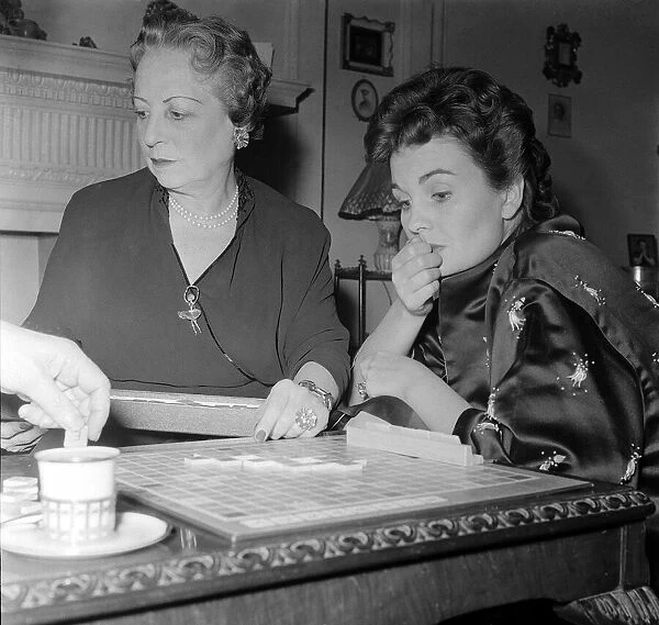 Actress Jean Simmons, right, with her former teacher Ada Foster playing a game of