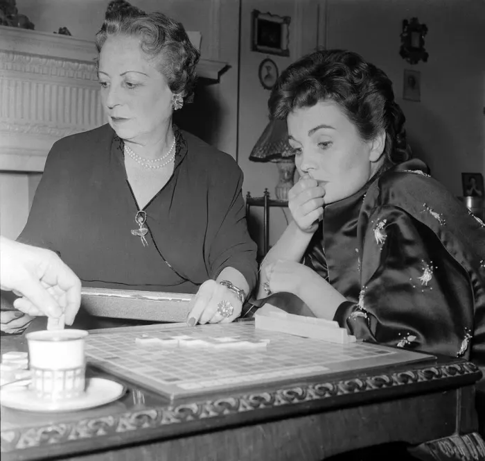 Framed Print : Actress Jean Simmons, right, with her former teacher Ada Foster playing a game of